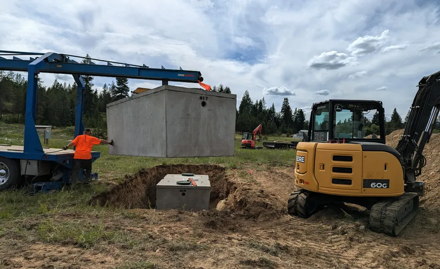Lowering the first septic tank into place