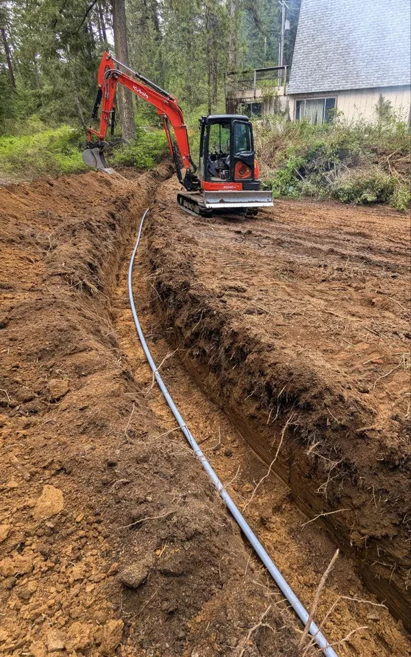 Laying a water line in a trench